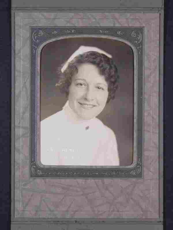 Portrait of a smiling woman in a nurses uniform, framed in an ornate studio photo mat.